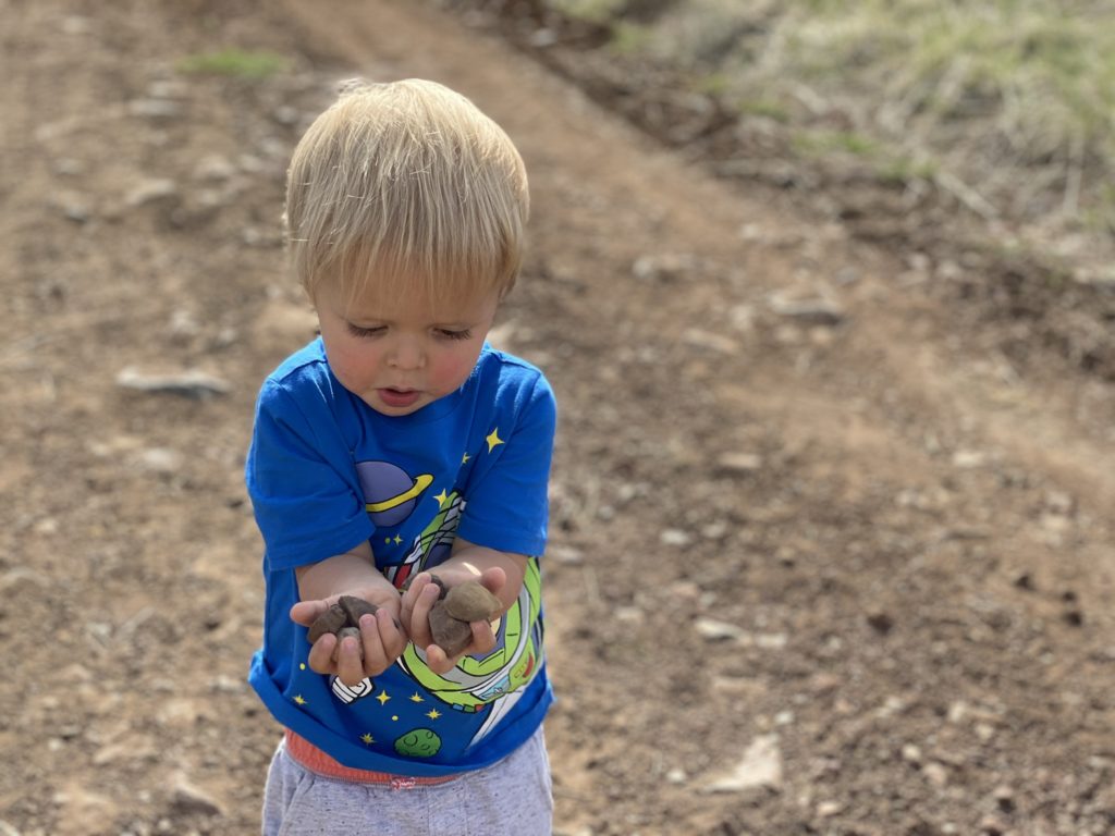 toddler showing rock collection