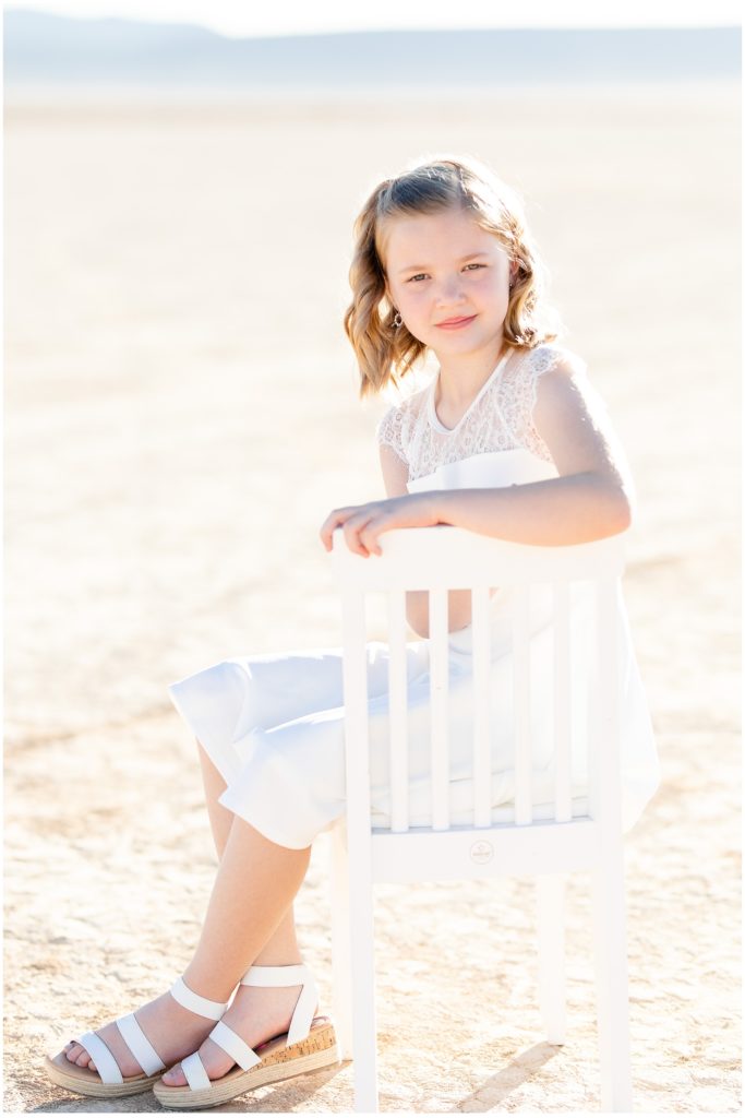 White dress, girl on chair, dry lake bed